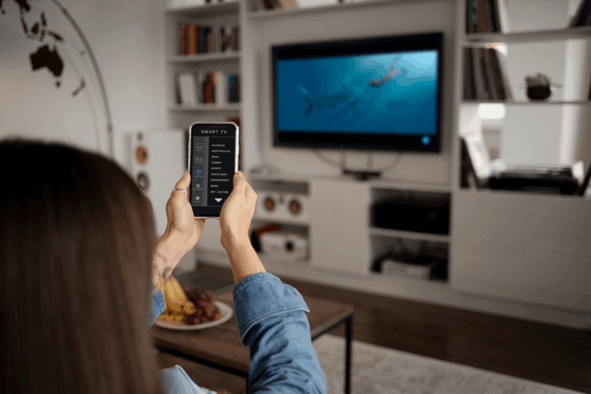 Mulher assistindo à TV OLED da Casas Bahia